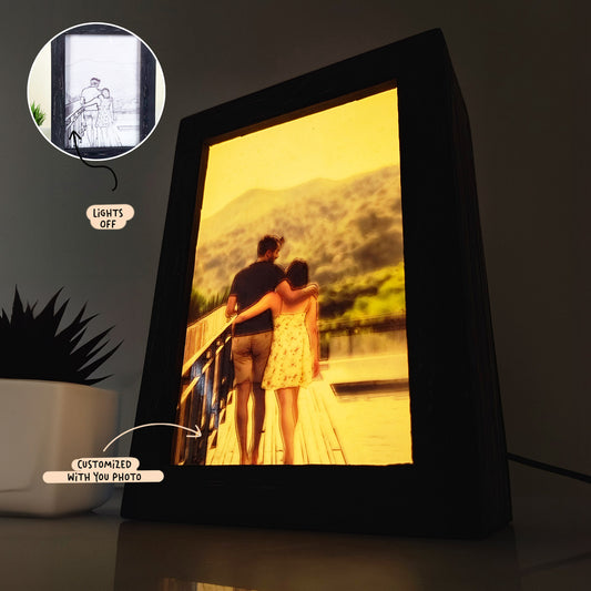 A Custom Photo Light Box showing a couple on a bridge with mountains in the background. Inset image displays the photo when the lamp is off. Caption labels: "Lights off" and "Customized with your photo.