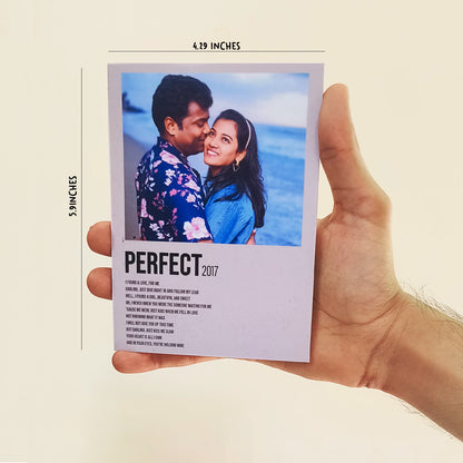 A hand is holding a card with a photo featuring a smiling couple embracing in front of the ocean. The card, titled "PERFECT 2022," has a list of words below it. The card's dimensions (4.19 inches wide by 5.9 inches tall) are indicated at the top.